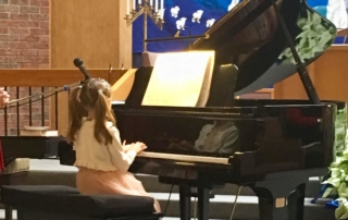 Young female student playing piano