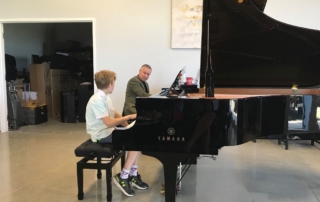 Piano teacher and student during piano lesson