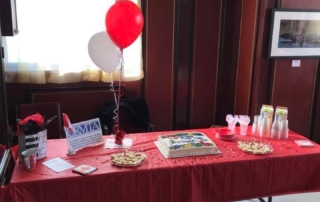 Table set up with cake and treats at London ORMTA event